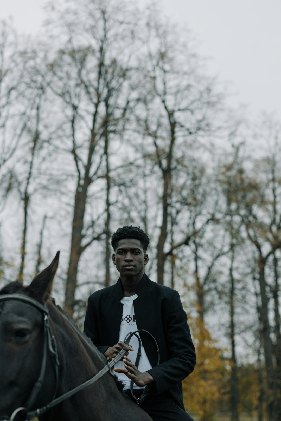 GOE Collection Photoshoot model riding a horse wearing shirt